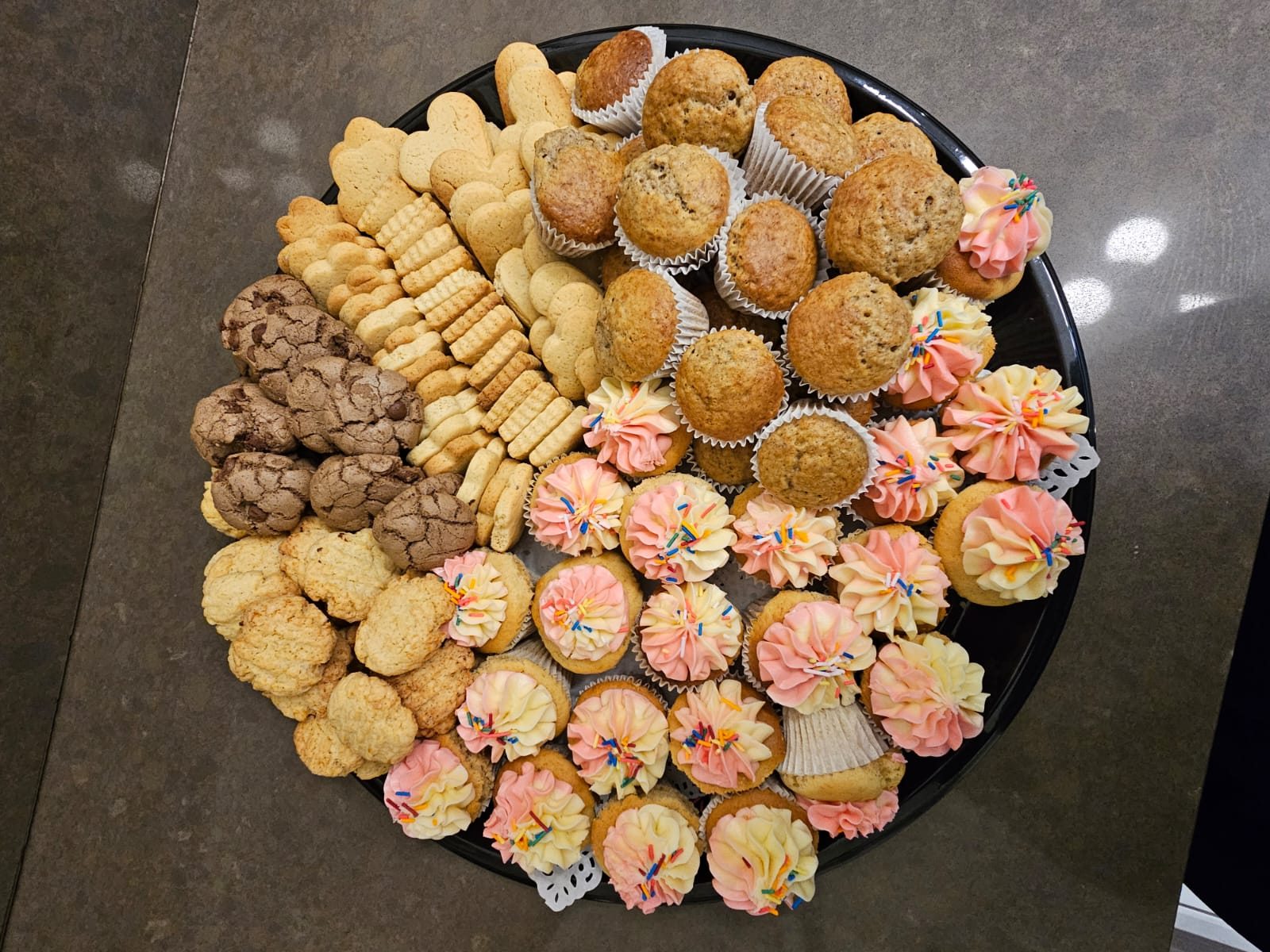 A generous platter of cupcakes, muffins and assorted home-baked biscuits