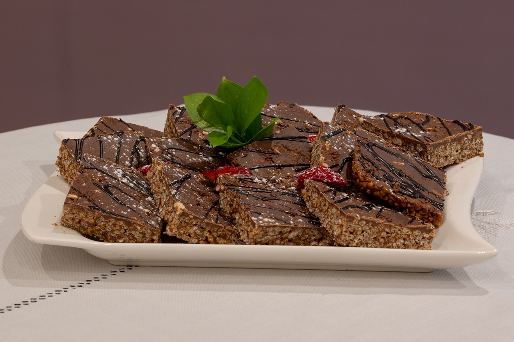 Chocolate crunch slices arranged on a white platter