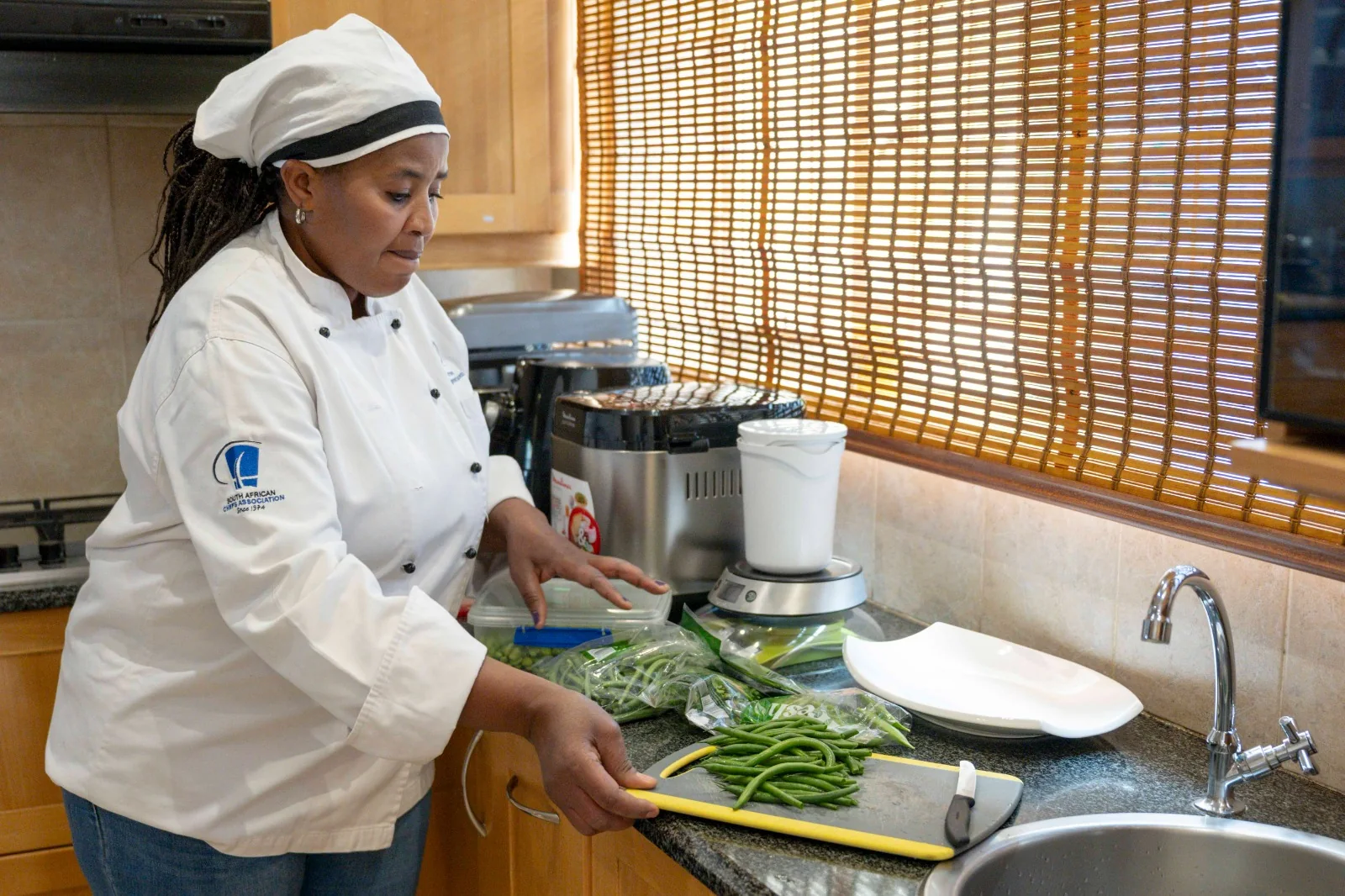 Joyce preparing fresh vegetables for a home-cooked order